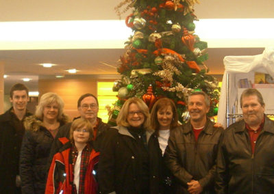 People in front of a Christmas tree